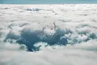 Airplane in flight into the clouds
