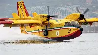 Canadair CL-415 airplane during a water refuelling in a firefighting operation