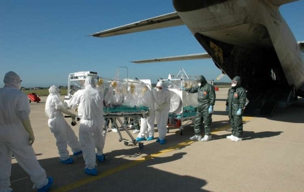 Special litter with an alleged infective patient is taken aboard a C-130J aircraft of Italian Air Force to be transported from Turin to Rome