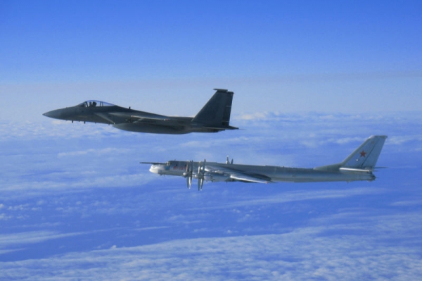From top to bottom: F-15C and Tupolev TU-95MS Bear fighter aircraft in an archive photo