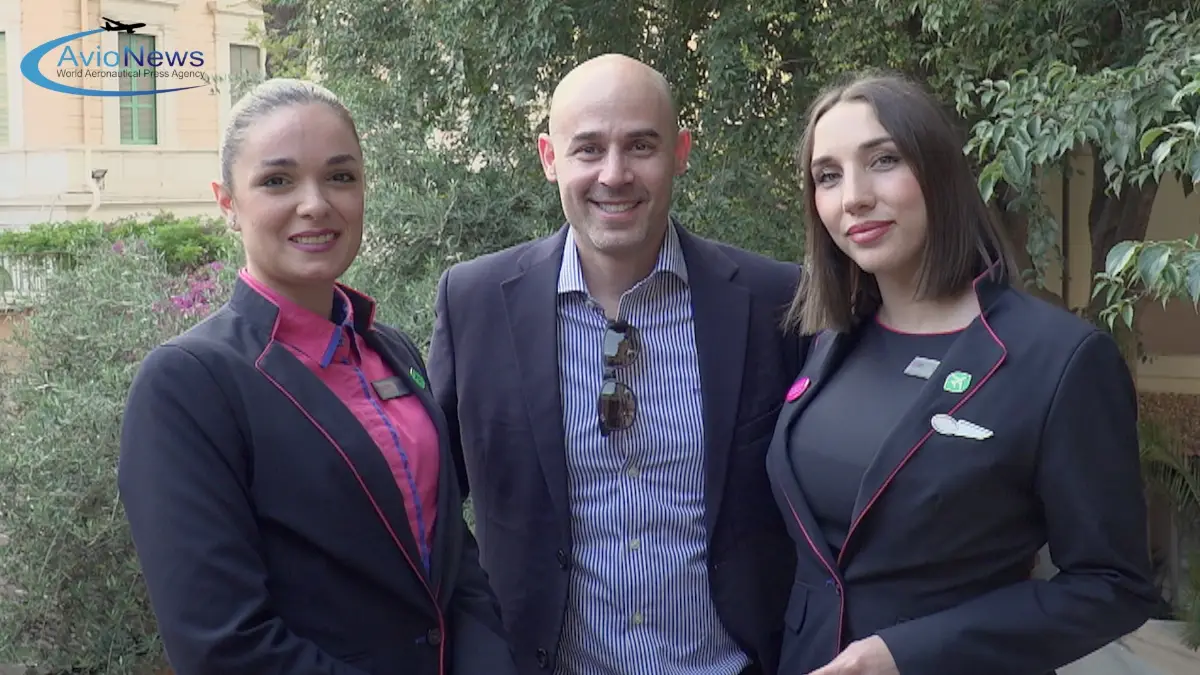 Andras Rado, head of communication of Wizz Air, with two hostess