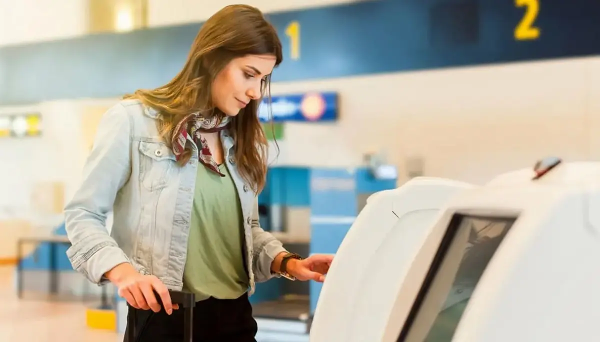 Passenger at a self check-in machine inside an airport