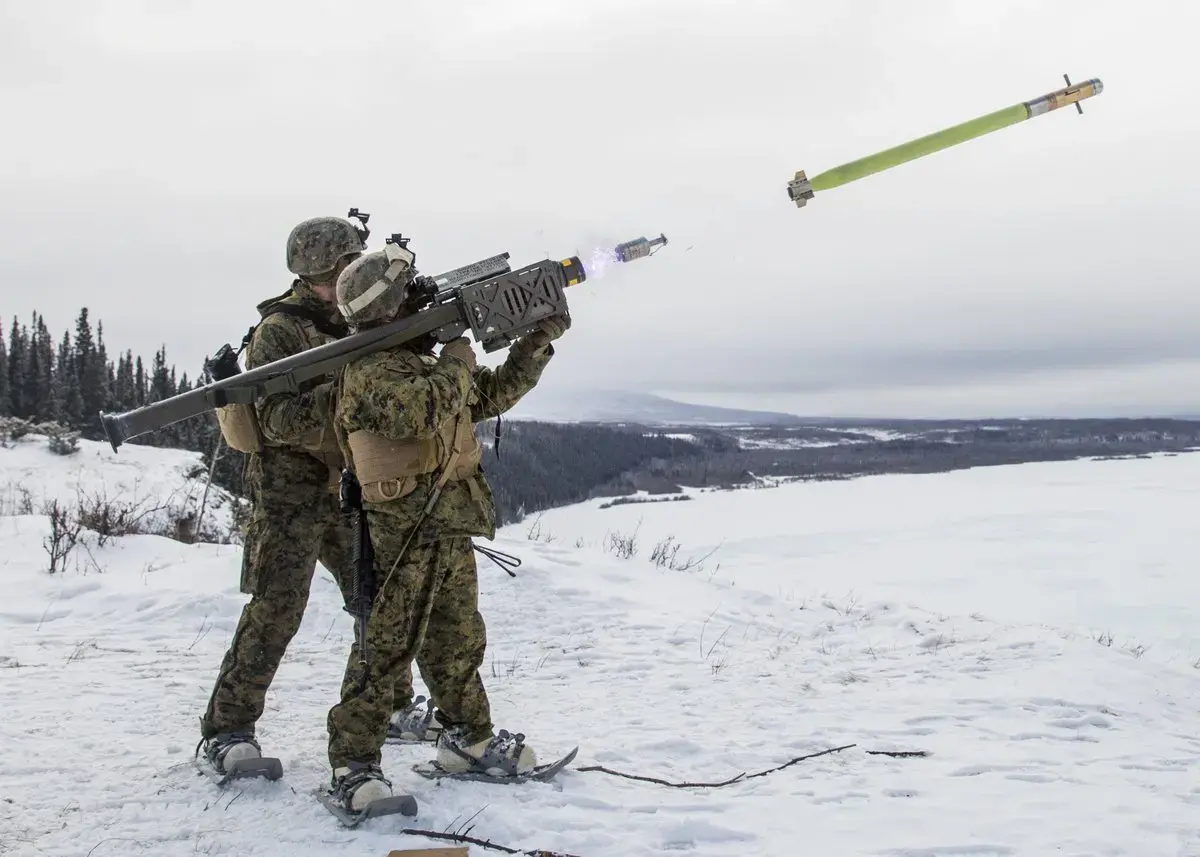 Two military personnel firing an FIM-92 Stinger anti-aircraft missile