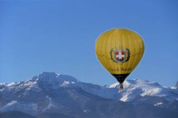 Balloon of the Mondovì's City (Cuneo, Piemonte Region) with a background of snow-covered mountains