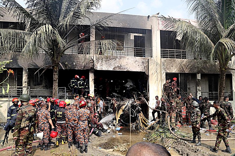The wreckage of the Bangladesh Air Force Chengdu F-7 BGI aircraft can be seen, which crashed near the entrance to a student campus in a neighborhood of Dhaka on July 21, 2025
