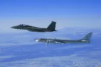From top to bottom: F-15C and Tupolev TU-95MS Bear fighter aircraft in an archive photo