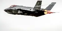 An F-35A uf USAF in flight with the afterburner turned on